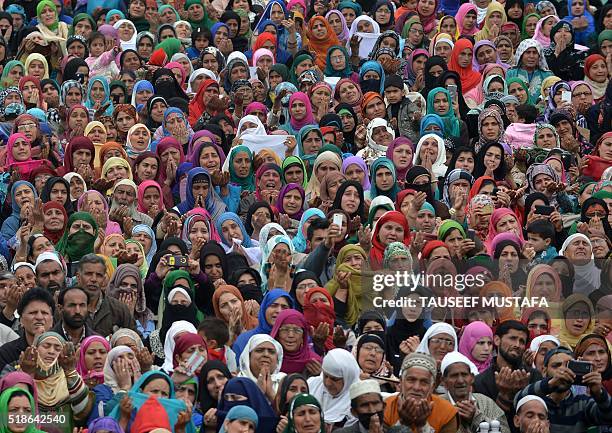 Indian Kashmiri Muslims pray before a priest shows a relic believed to be hair from the beard of Prophet Muhammed during special prayers on the death...