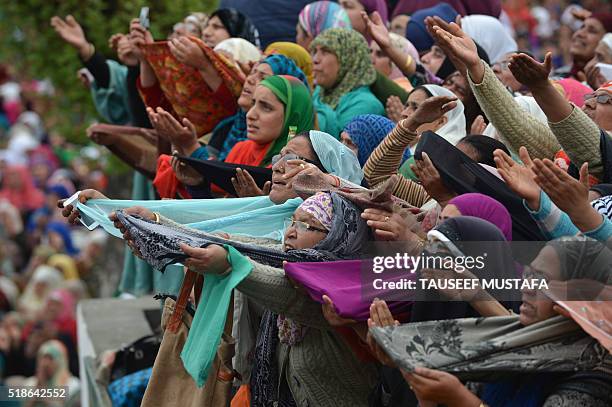 Indian Kashmiri Muslims pray before a priest shows a relic believed to be hair from the beard of Prophet Muhammed during special prayers on the death...