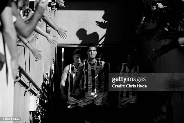 Andrew Swallow of the Kangaroos leads the team out for the round two AFL match between the Brisbane Lions and the North Melbourne Kangaroos at The...