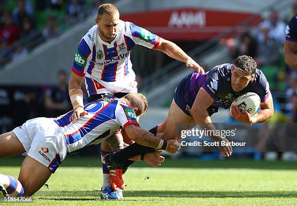 Dale Finucane of the Storm is tackled during the round five NRL match between the Melbourne Storm and the Newcastle Knights at AAMI Park on April 2,...