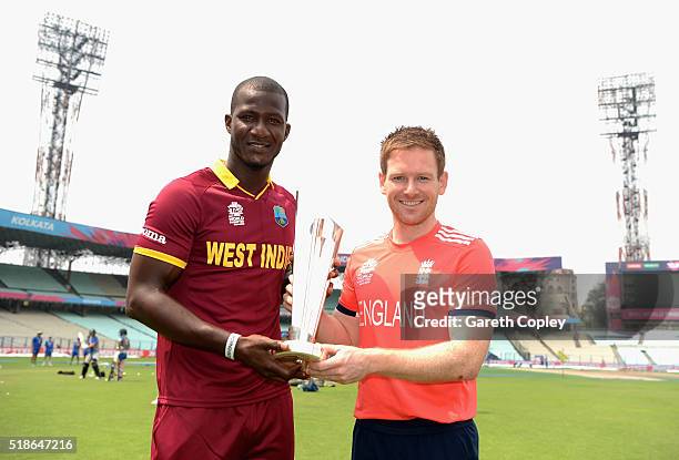 Darren Sammy of the West Indies and England captain Eoin Morgan pose with the ICC World T20 trophy ahead of tomorrrow's ICC World Twenty20 India 2016...