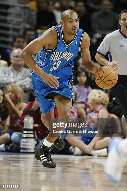 Grant Hill of the Orlando Magic drives against the Denver Nuggets during the game on December 6, 2004 at Pepsi Center in Denver, Colorado. The...