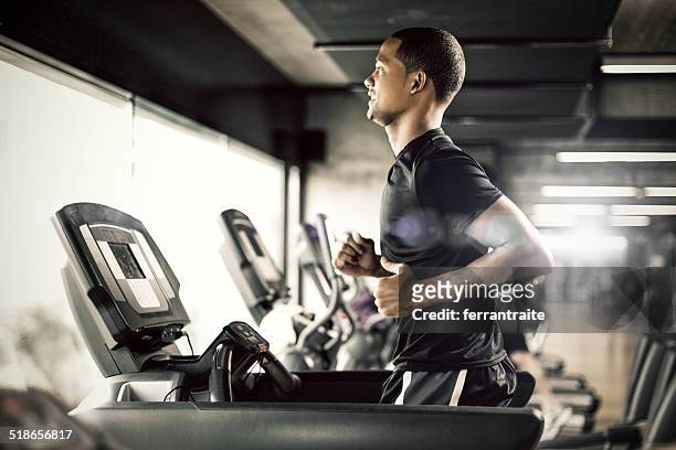 healthy man running on treadmill - health club stock pictures, royalty-free photos & images