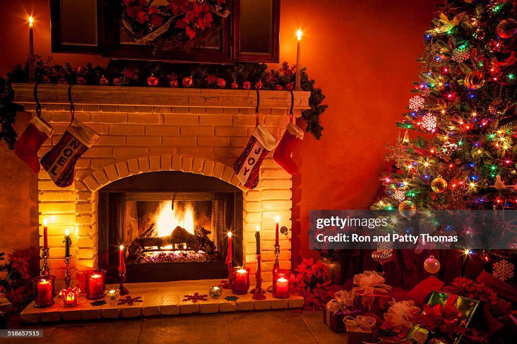 Christmas living room with fireplace and presents under tree (P)