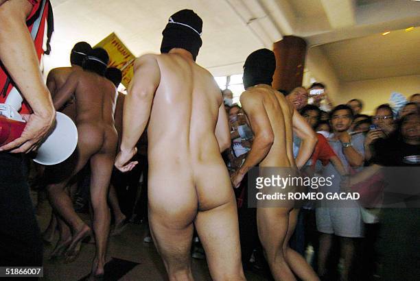 Some 20 naked members of the Alpha Phi Omega fraternity run past a huge crowd of students at the Arts and Sciences building in the University of...