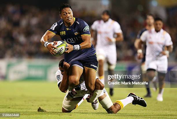 Christian Lealiifano of the Brumbies is tackled by Michael Leitch of the Chiefs during the round six Super Rugby match between the Brumbies and the...