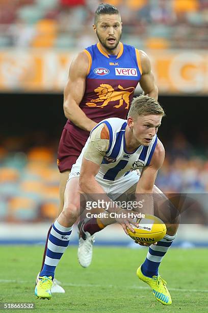 Jack Ziebell of the Kangaroos handballs during the round two AFL match between the Brisbane Lions and the North Melbourne Kangaroos at The Gabba on...