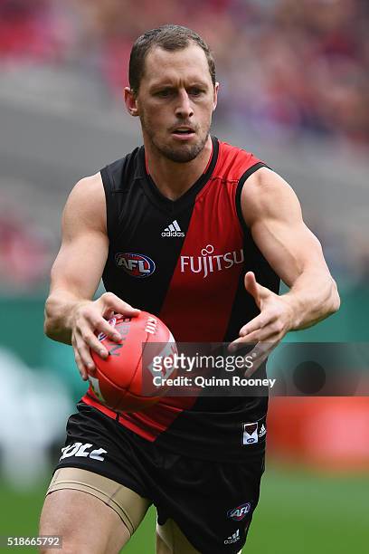 James Kelly of the Bombers kicks during the round two AFL match between the Essendon Bombers and the Melbourne Demons at the Melbourne Cricket Ground...