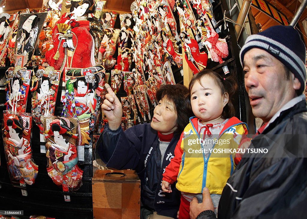Shop owners show colorful wooden battled