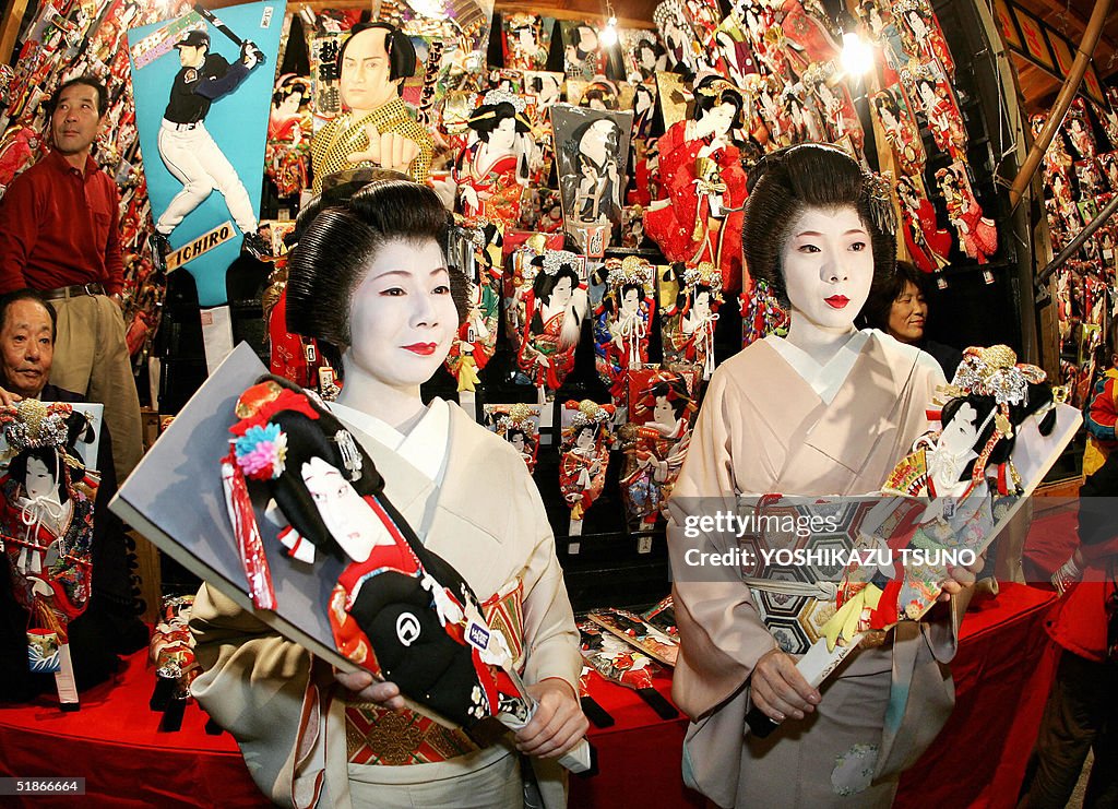 Geishas Chino (L) and Chizuru admire woo