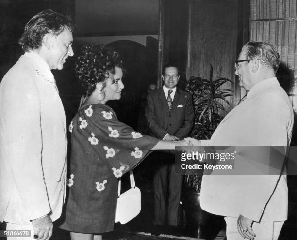 Yugoslavian President Josip Broz Tito greets films stars Elizabeth Taylor and her husband Richard Burton at his summer residence on Brioni island,...