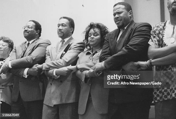 Former Executive Director of the National Association for the Advancement of Colored People Benjamin Chavis Jr and small group of people holding...