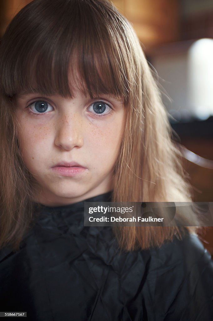 Small girl having hair cut