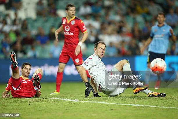 Iacopo LA Rocca and Eugene Galekovic of Adelaide United watch the ball after clashing in defence during the round 26 A-League match between Sydney FC...