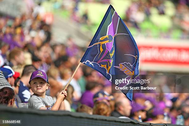 Storm supporter in the crowd waves his flag during the round five NRL match between the Melbourne Storm and the Newcastle Knights at AAMI Park on...