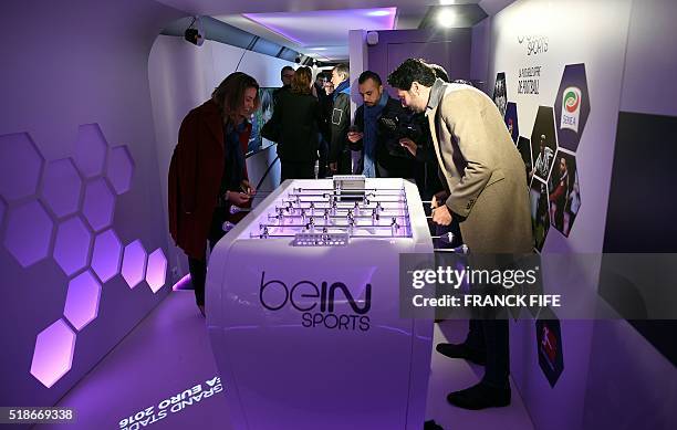 French journalist Alexandre Ruiz plays with BeIn Sports journalist Anne-Laure Bonnet in the "UEFA EURO 2016 Trophy tour" train stationed in Gare de...