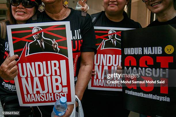 Protesters show placards during a rally against Prime Minister Najib Razak and GST at Independent Square on April 2, 2016 in Kuala Lumpur, Malaysia....