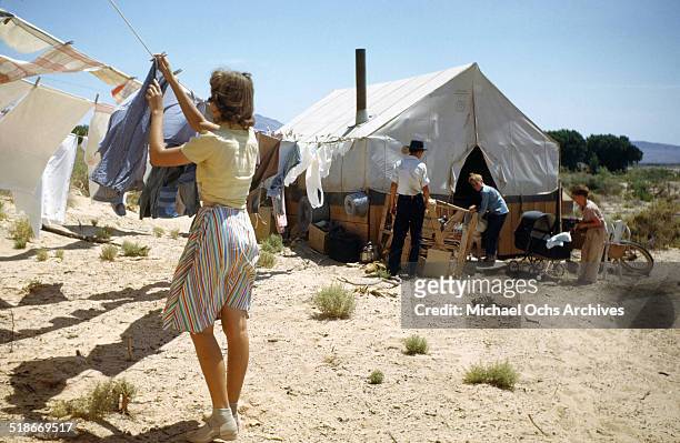 View as a women hangs her clothes to dry at Tent City Nevada, housing for workers and thier families at the Basic Magnesium Incorporated a Magnesium...