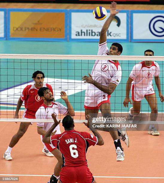 Raed Said al-Hashemi of Oman spikes the ball against UAE player Sami Jassem at the 17th Arabian volleyball Gulf Cup tournament at al-Rayyan court, 16...