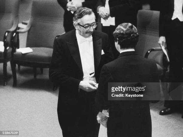 British scientist Sir Godfrey Hounsfield , joint Nobel Laureate in Medicine, receives his prize from King Carl Gustaf at the award ceremony in...