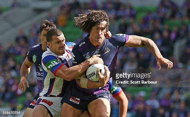 Kevin Proctor of the Storm is tackled during the round five NRL match between the Melbourne Storm and the Newcastle Knights at AAMI Park on April 2,...