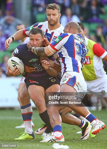 Blake Green of the Storm is tackled during the round five NRL match between the Melbourne Storm and the Newcastle Knights at AAMI Park on April 2,...
