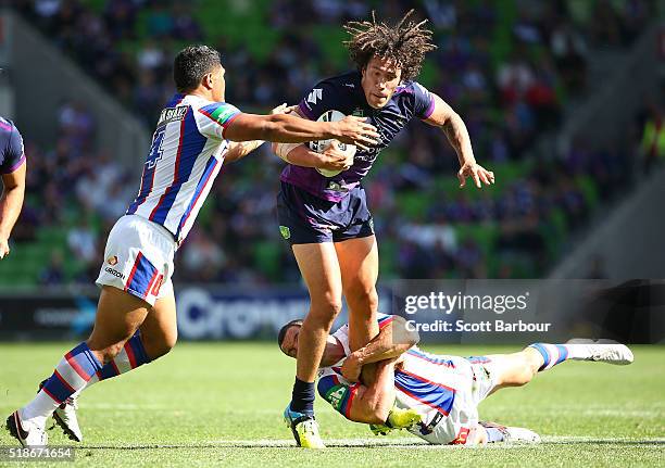 Kevin Proctor of the Storm is tackled during the round five NRL match between the Melbourne Storm and the Newcastle Knights at AAMI Park on April 2,...