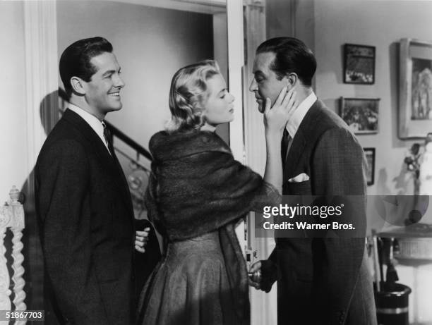 American actors Robert Cummings and Grace Kelly with Welsh actor Ray Milland in a scene from the film 'Dial "M" for Murder' directed by Alfred...