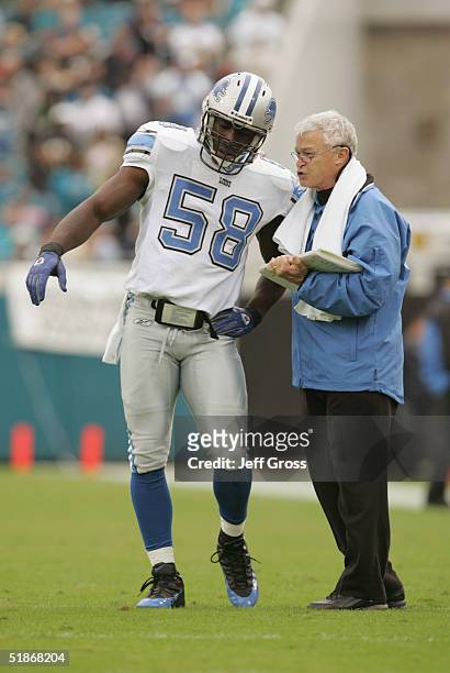 Line backer Wali Rainer of the Detroit Lions speaks with special teams coordinator Chuck Priefer while facing the Jacksonville Jaguars at Alltel...