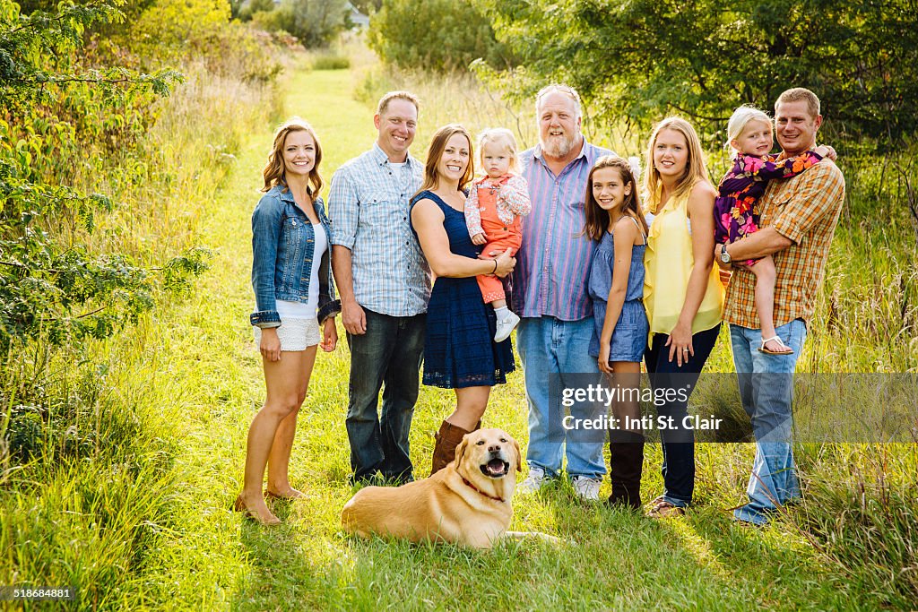 Multi-generational family portrait on farm, sunset