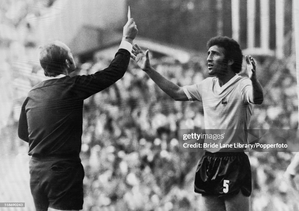 Hungarian referee Károly Palotai shows the red card to Uruguayan