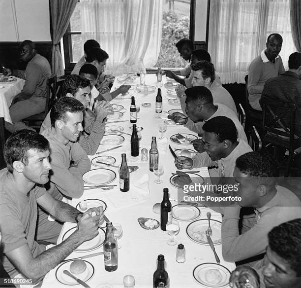 Members of the Brazilian World Cup football team at a dinner table at their training camp in Nova Friburgo, Brazil, 1962. Among the players are...