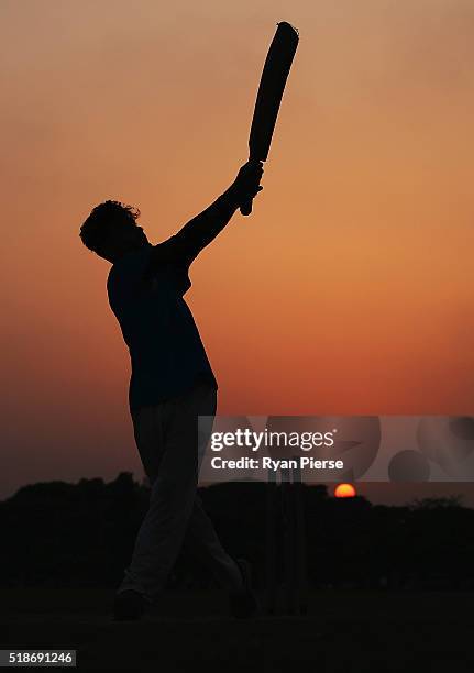 Locals play cricket on the Maidan at sunset ahead of the ICC World Twenty20 India Final between England and West Indies at Eden Gardens on April 2,...