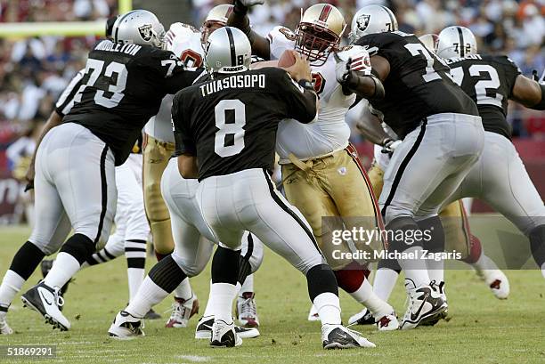 San Francisco 49ers defensive tackle Josh Shaw puts pressure on quarterback Marques Tuiasosopo during a 14 to 10 win over the Oakland Raiders in a...