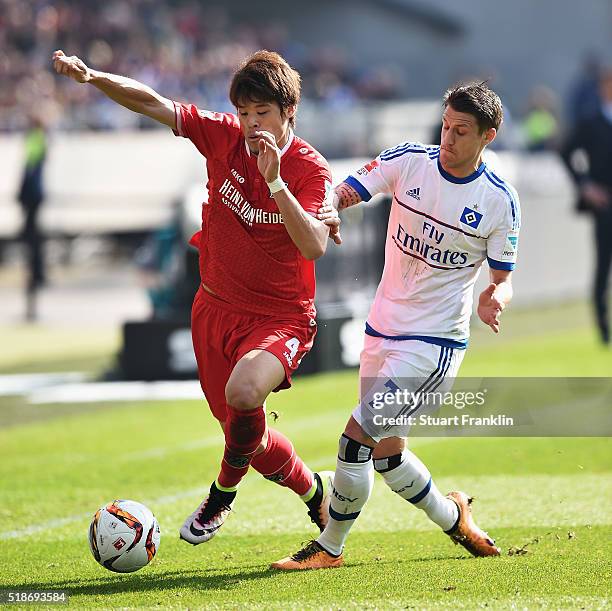 Of Hamburg is challenged by Hiroki Sakai of Hannover during the Bundesliga match between Hannover 96 and Hamburger SV at HDI-Arena on April 2, 2016...