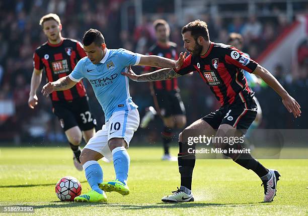 Sergio Aguero of Manchester City controls the ball under pressure of Steve Cook of Bournemouth during the Barclays Premier League match between...