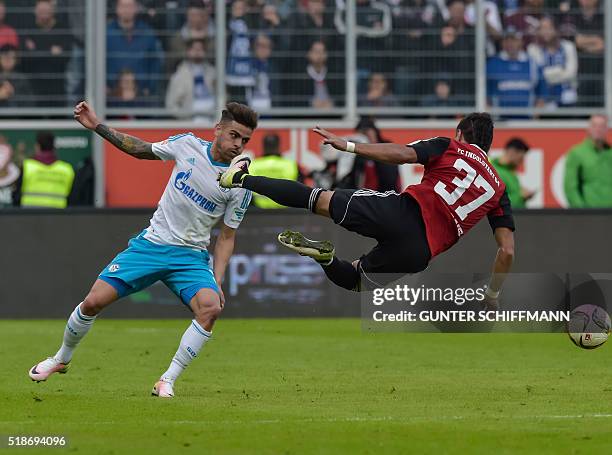 Schalke's Brazilian defender Junior Caicara fouls Ingolstadt's striker Dario Lezcano during the German first division Bundesliga football match FC...