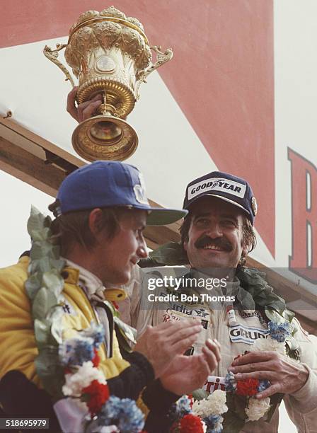 Clay Regazzoni of Switzerland driver of the Albilad-Saudi Racing Team Williams FW07 Cosworth V8 celebrates with second placed Rene Arnoux after...