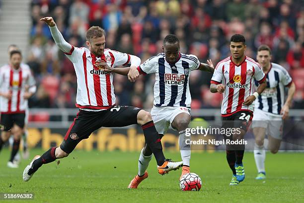 Saido Berahino of West Bromwich Albion is tackled by Jan Kirchhoff of Sunderland during the Barclays Premier League match between Sunderland and West...