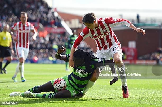 Bafetimbi Gomis of Swansea City and Philipp Wollscheid of Stoke City compete for the ball during the Barclays Premier League match between Stoke City...