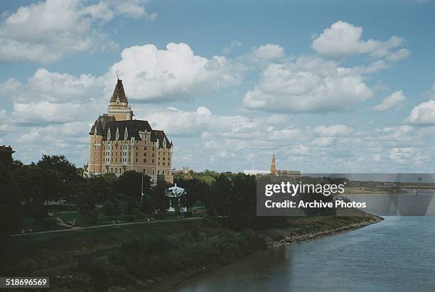 Kiwanis Park and the Bessborough Hotel on the South Saskatchewan River in Saskatoon, Saskatchewan, Canada, circa 1960.