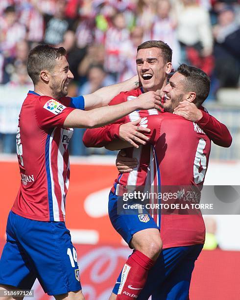 Atletico Madrid's French forward Antoine Griezmann celebrates with teammates after scoring during the Spanish league football match Club Atletico de...