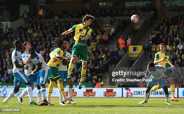 Timm Klose of Norwich City heads the ball to score his team's first goal during the Barclays Premier League match between Norwich City and Newcastle...
