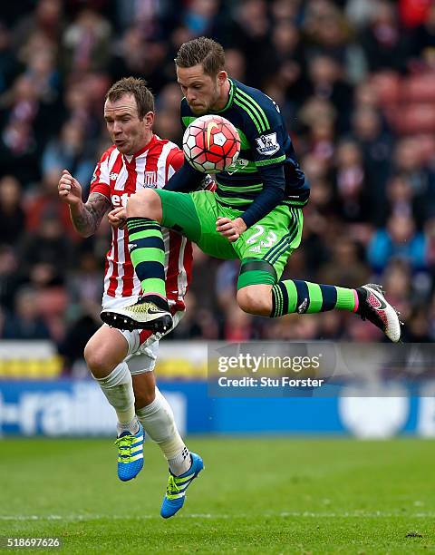 Stoke player Glenn Whelan challenges Gylfi Sigurdsson of Swansea during the Barclays Premier League match between Stoke City and Swansea City at...