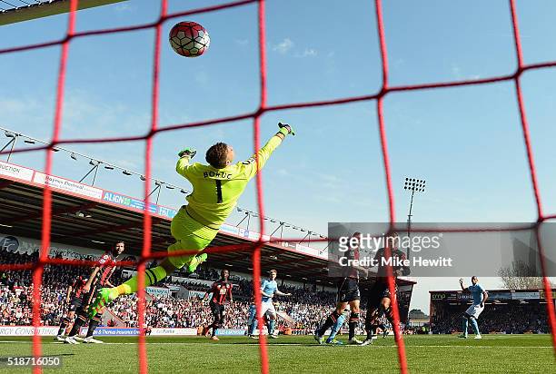 Artur Boruc of Bournemouth dives in vain as Kevin de Bruyne of Manchester City scores his team's first goal during the Barclays Premier League match...