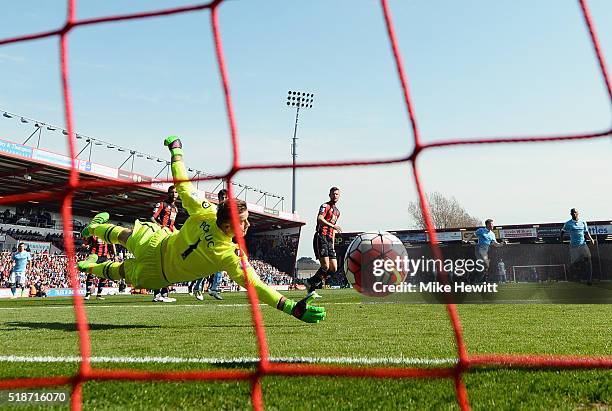 Artur Boruc of Bournemouth dives in vain as Kevin de Bruyne of Manchester City scores his team's second goal during the Barclays Premier League match...