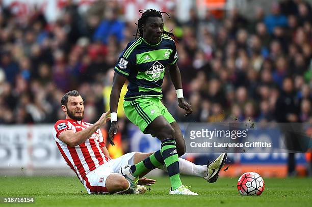 Bafetimbi Gomis of Swansea City is tackled by Erik Pieters of Stoke City during the Barclays Premier League match between Stoke City and Swansea City...