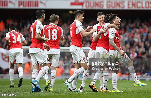 Hector Bellerin of Arsenal celebrates scoring his team's third goal with his team mates during the Barclays Premier League match between Arsenal and...