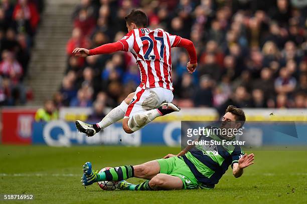 Bojan Krkic of Stoke City is tackled by Federico Fernandez of Swansea City during the Barclays Premier League match between Stoke City and Swansea...