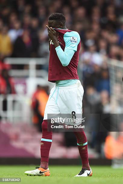 Cheikhou Kouyate of West Ham United walks off the pitch after shown a red card during the Barclays Premier League match between West Ham United and...
